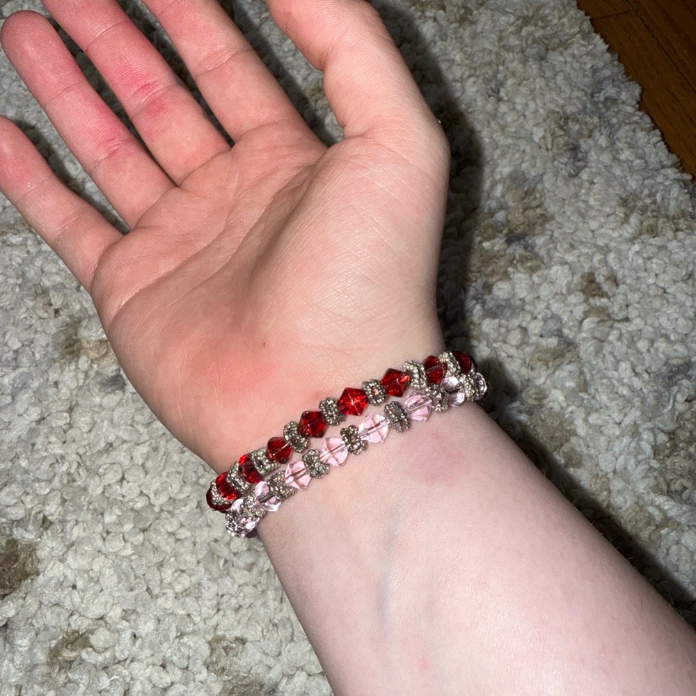 Bundle of pink and red beaded bracelets